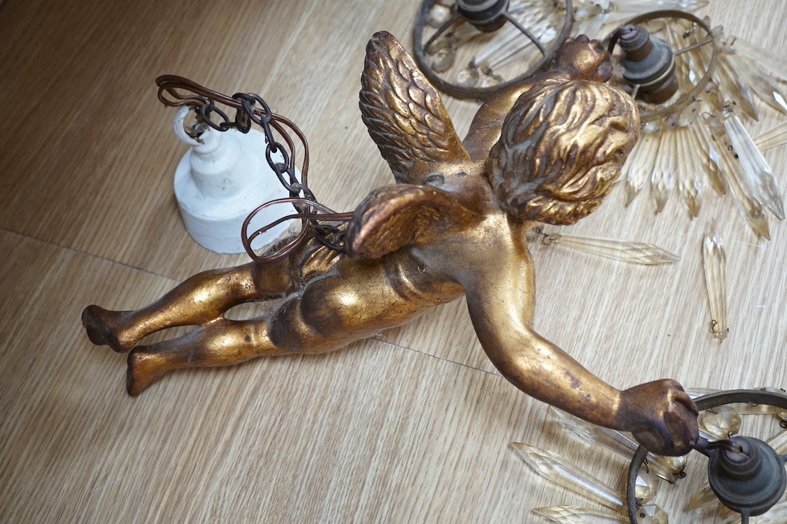 A pair of gilt twin branch cherub chandeliers with glass drops. Condition - some losses